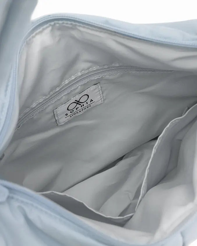 SIGNATURE POCKET CROSSBODY BAG IN COSY LUXE FROST